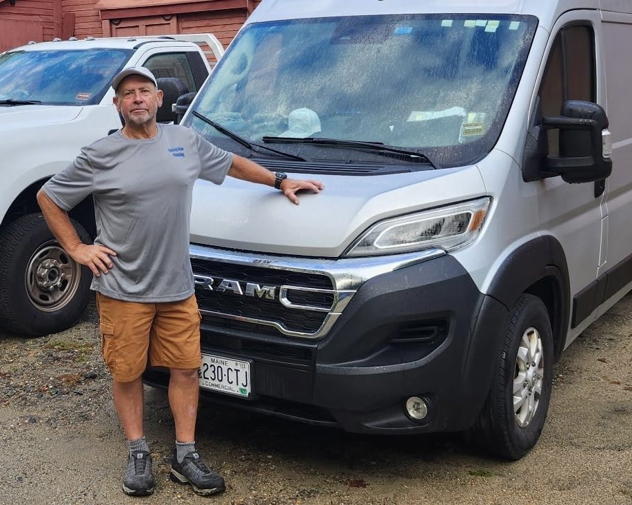 Rod Blow standing beside his Rodney Blow Plumbing service van in Kennebunk, Maine